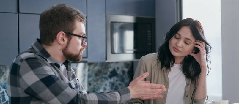 Disappointed man talking to his partner