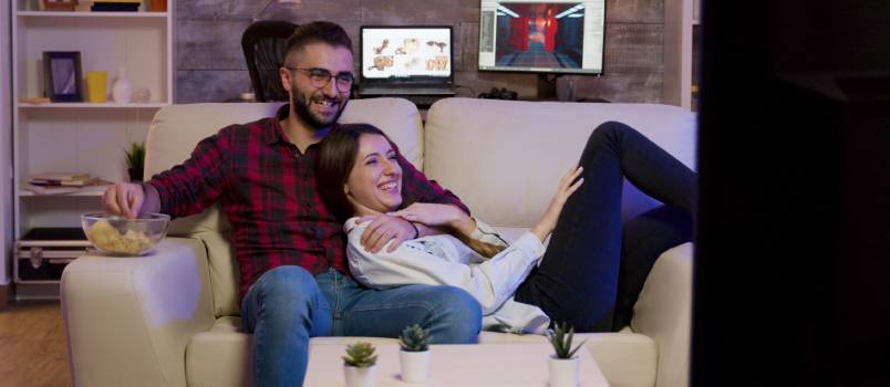 Young couple watching tv together