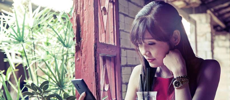 Sad woman using phone