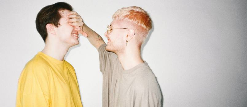 Man cover other man face with his hands