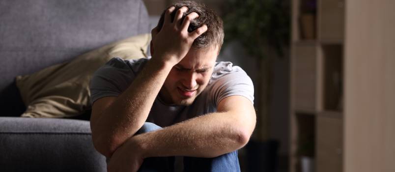 Sad man sitting on floor