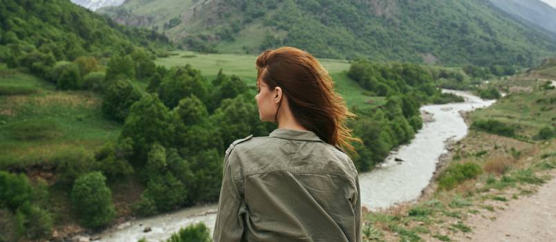 Woman sitting near the mountains