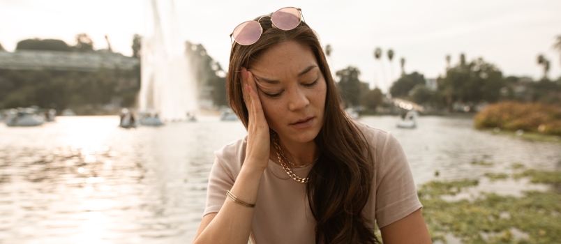 Woman sitting beside a lake