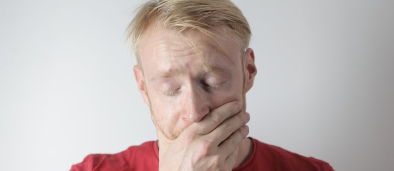 Stressed man covering his face