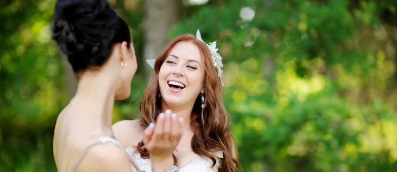Young bride hugging her friend