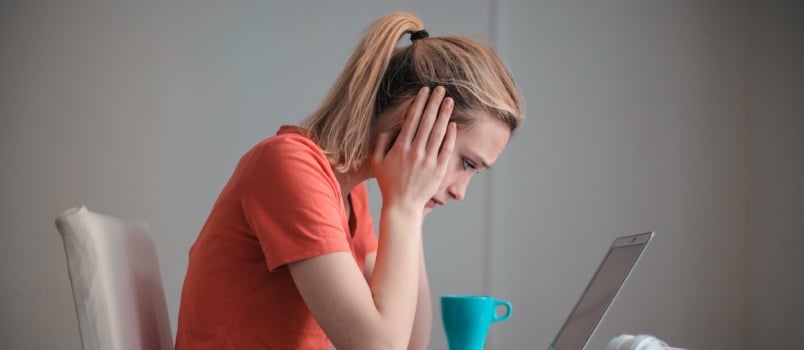 stressed woman working on laptop