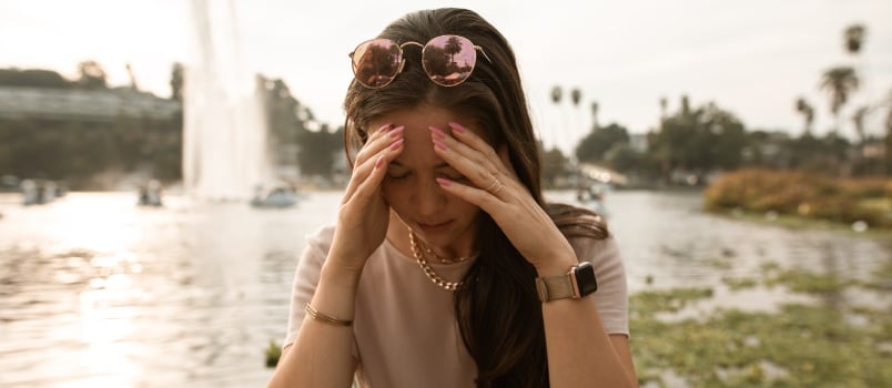 Woman sitting on a lake side