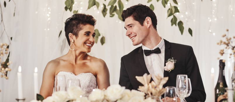 Couple sitting together at their wedding reception