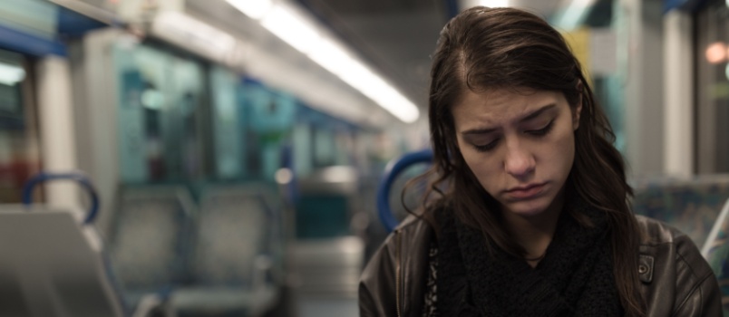 Woman in bus looking at phone