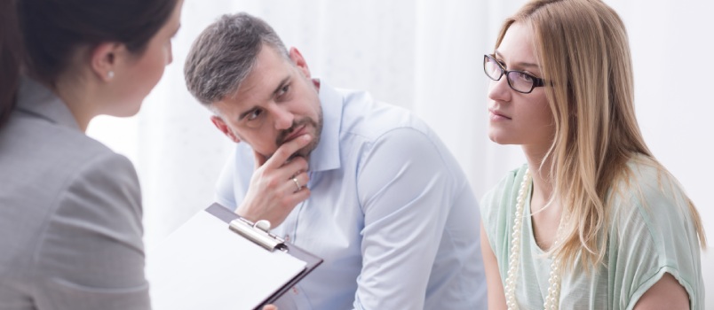 Upset young woman talking phycologist