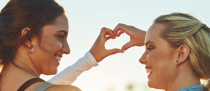 Friends making heart with their hands