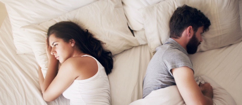 Couple laying on bed after fight