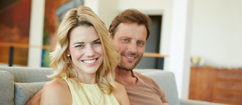 Couple relaxing on sofa together