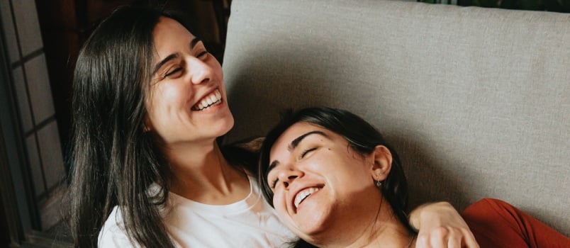 Happy woman laying on couch