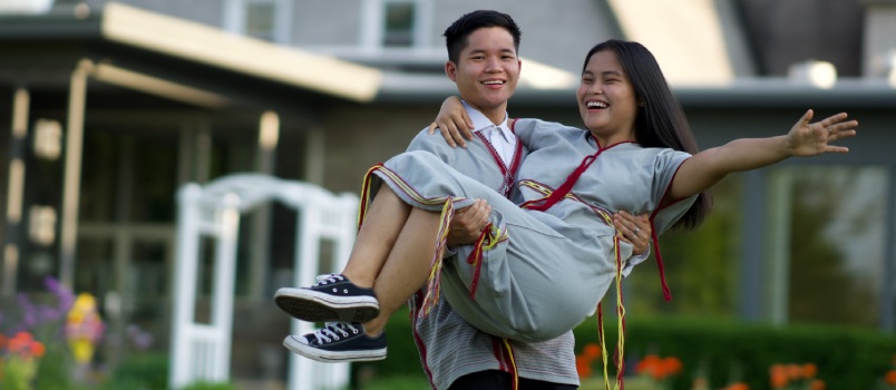 Young man holding girlfriend in arm