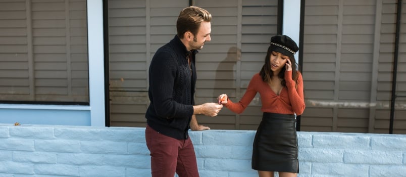Woman looking annoyed while talking to man