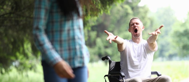 Woman walk away from man in wheelchair