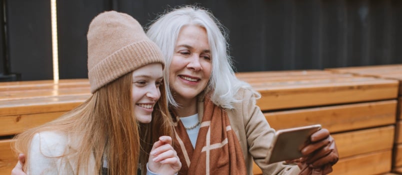 Grandmother and teenager taking selfie