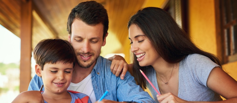 Couple and son coloring together