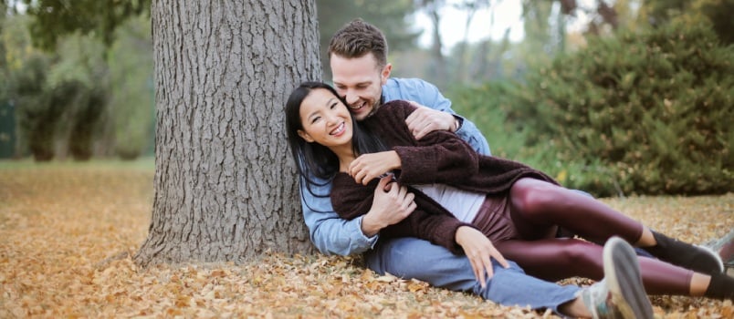 Couple reclining under the tree
