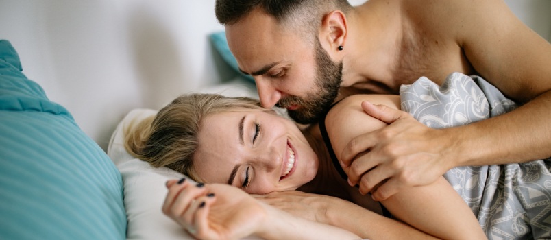 Couple cuddling in bedroom 