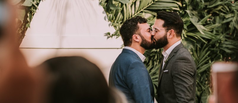 Young gay couple kissing