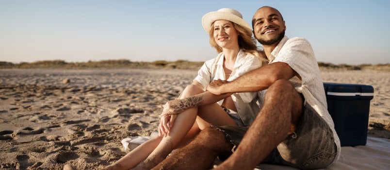 Beautiful couple sitting on the beach