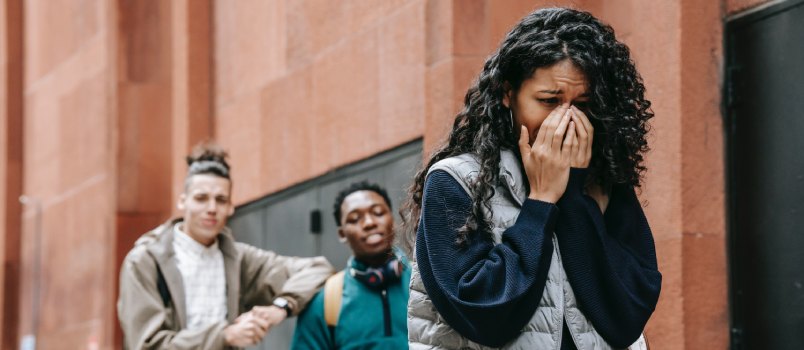 Male student gossiping about sad cry woman