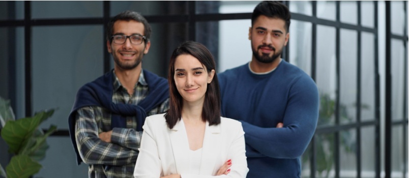 Three collegues standing in lobby 