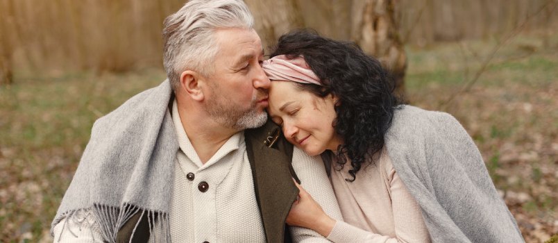 Happy senior couple hugging in autumn season