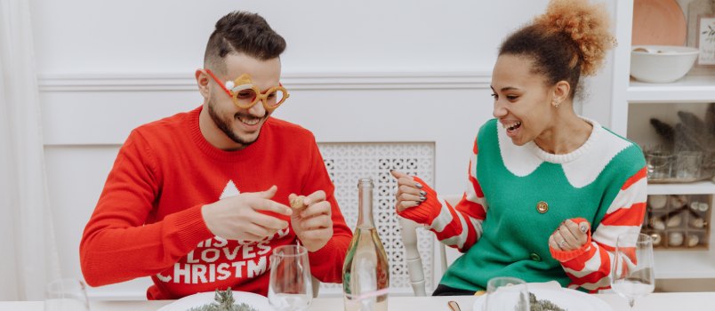 Man and woman wearing Christmas sweater