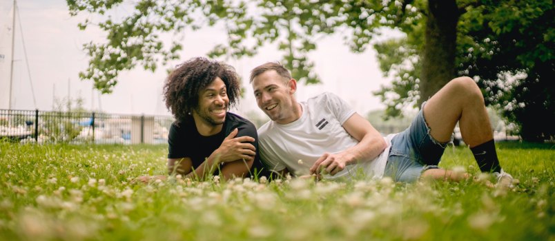 Smiling man laying on grass