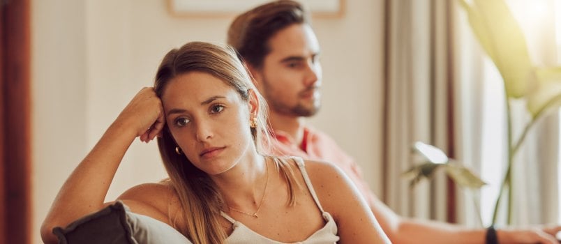 Angry couple sitting on couch 