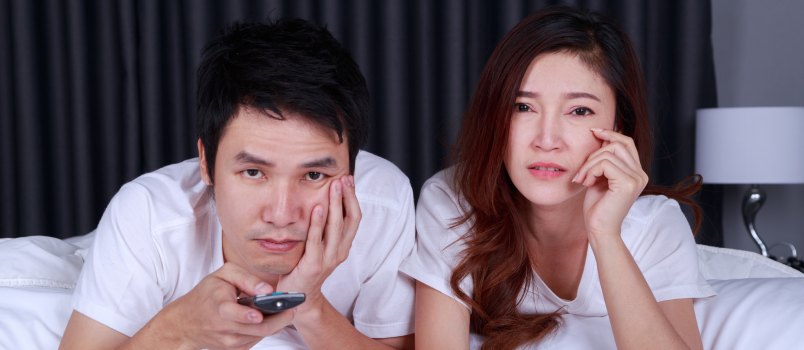 Young couple watching sad movie