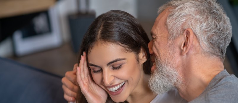 Old man having romance with young woman 