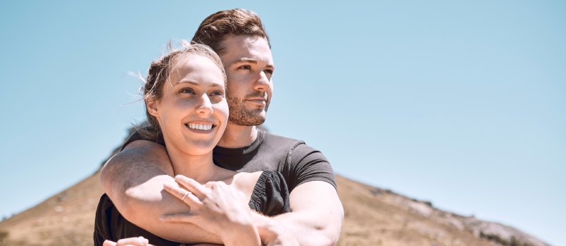 Man hugging woman from back