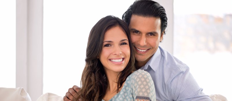 Happy couple sitting on couch