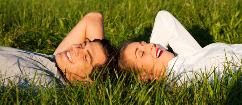 Couple sleeping on grass field