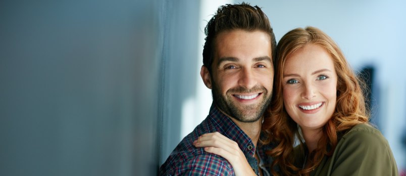 Happy couple looking in camera
