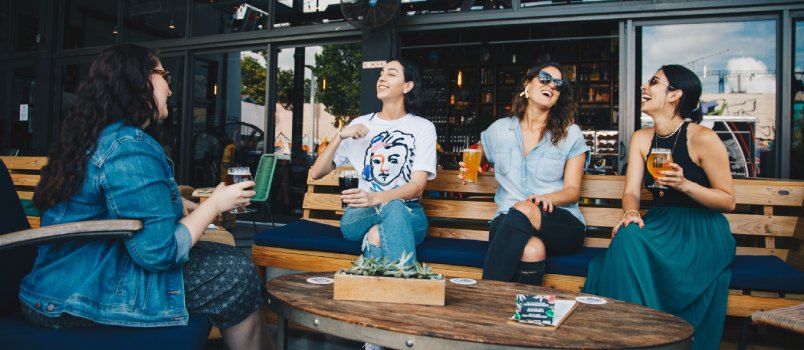 Friends chatting while having drinks
