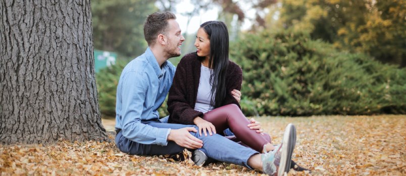 Couple sitting under the tree during daytime