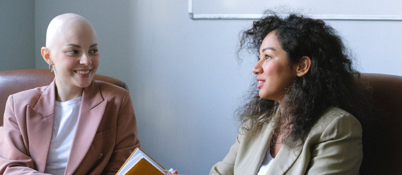 Smiling woman sitting the colleague in workspace