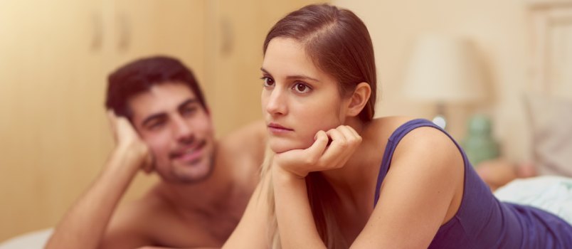 Woman laying on bed after having fight with boyfriend