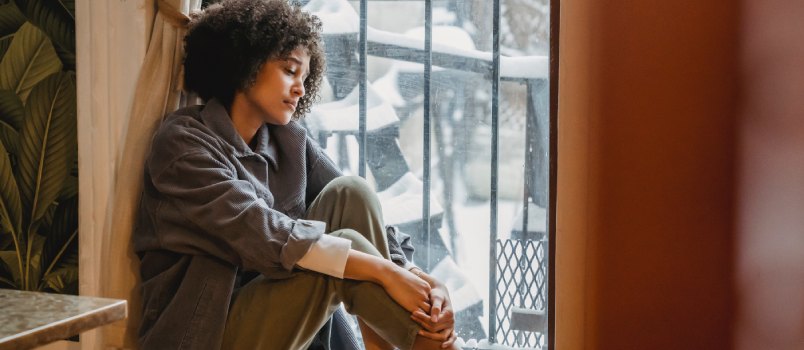 Woman sitting beside window