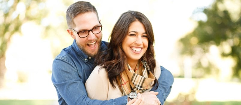 Man hugging woman from back