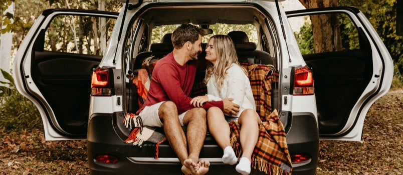 Couple sitting in the back of car
