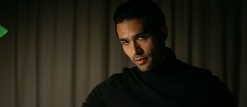 Man flipping pages of books in room