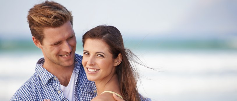 Couple happily embracing on the beach