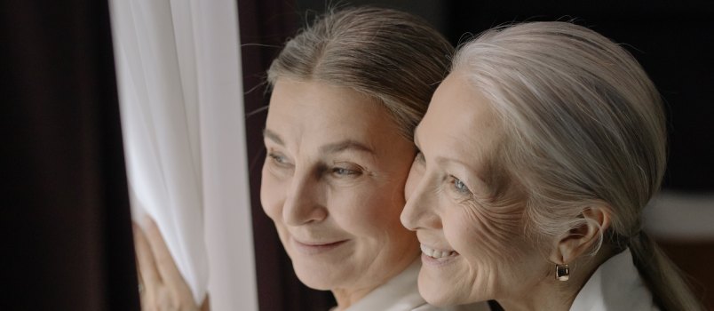 Elderly woman looking outside together