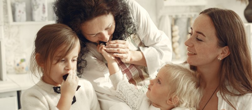 Family cooking cookies in kitchen